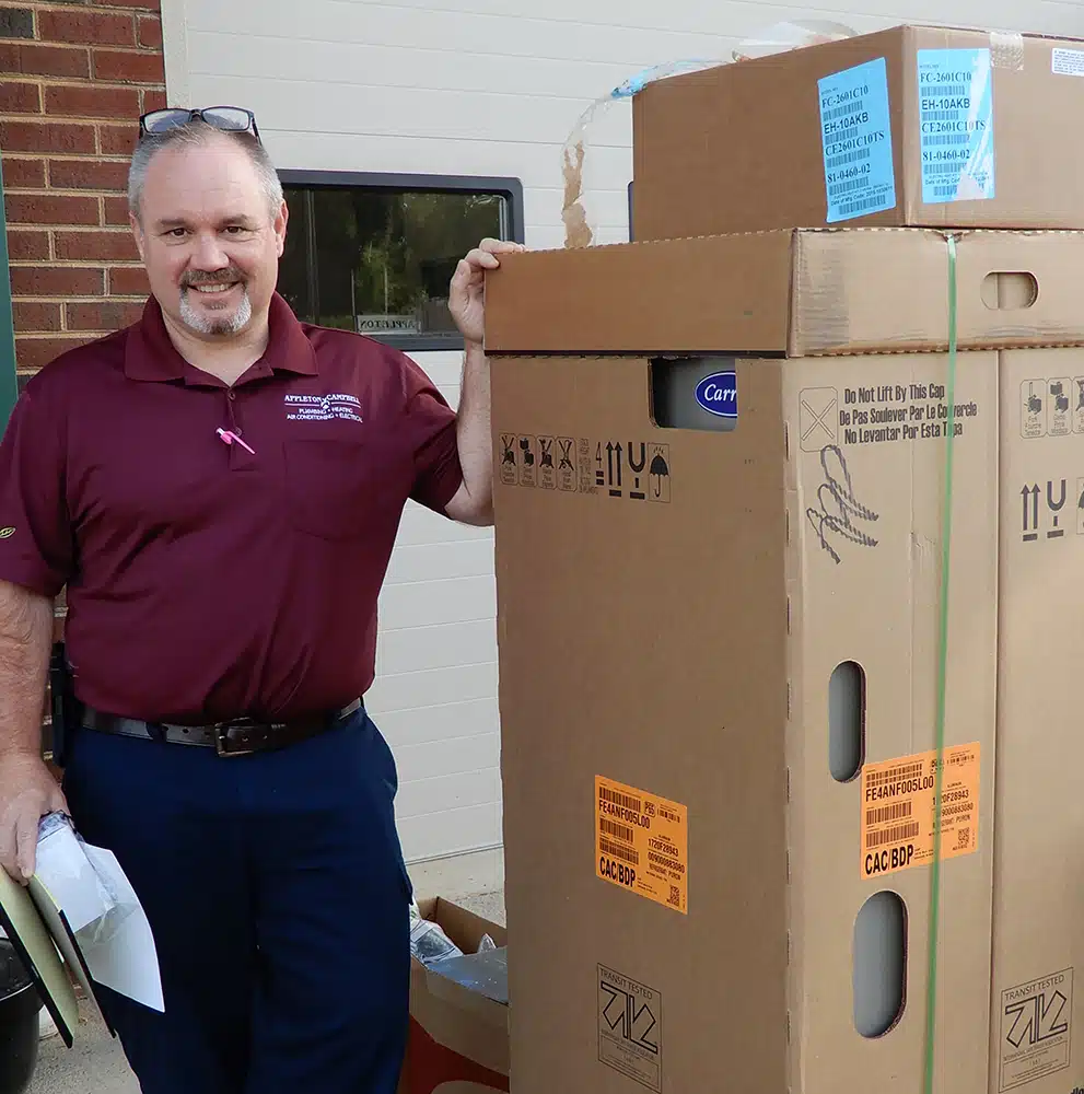 electrician unboxing a new unit in Warrenton, VA.