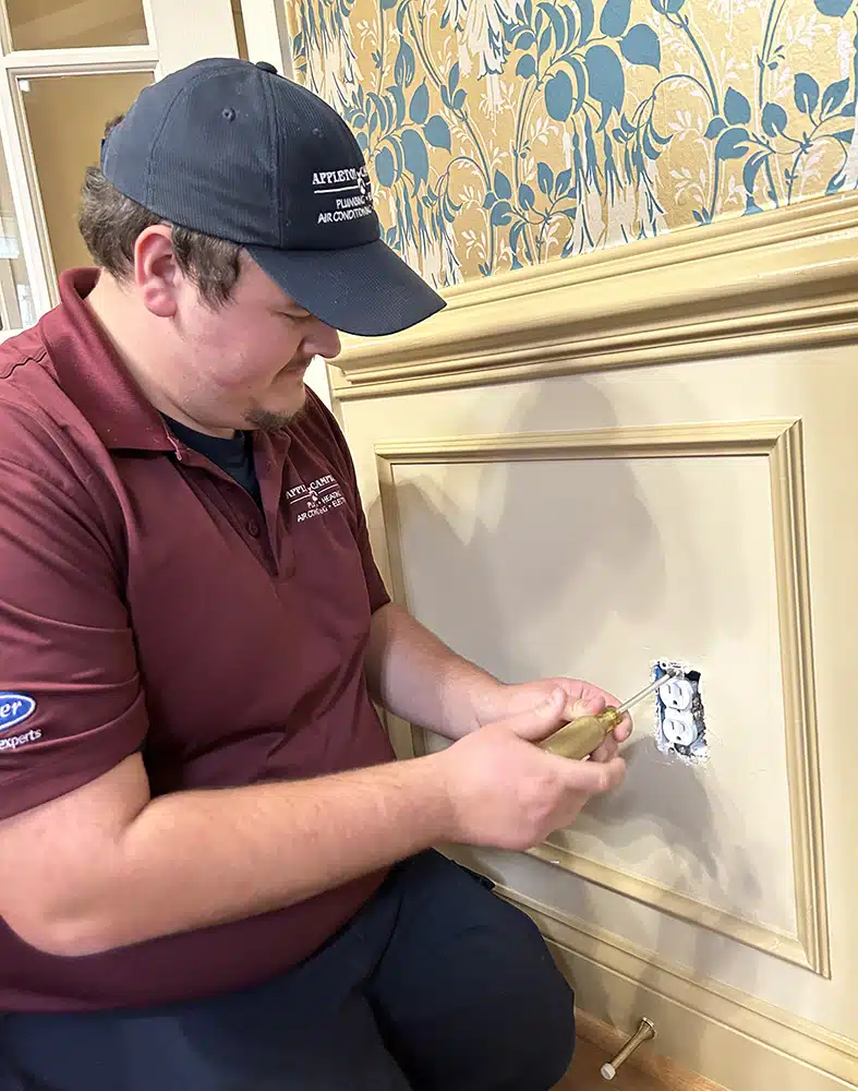 Technician servicing outlet in residential home in Warrenton, VA.