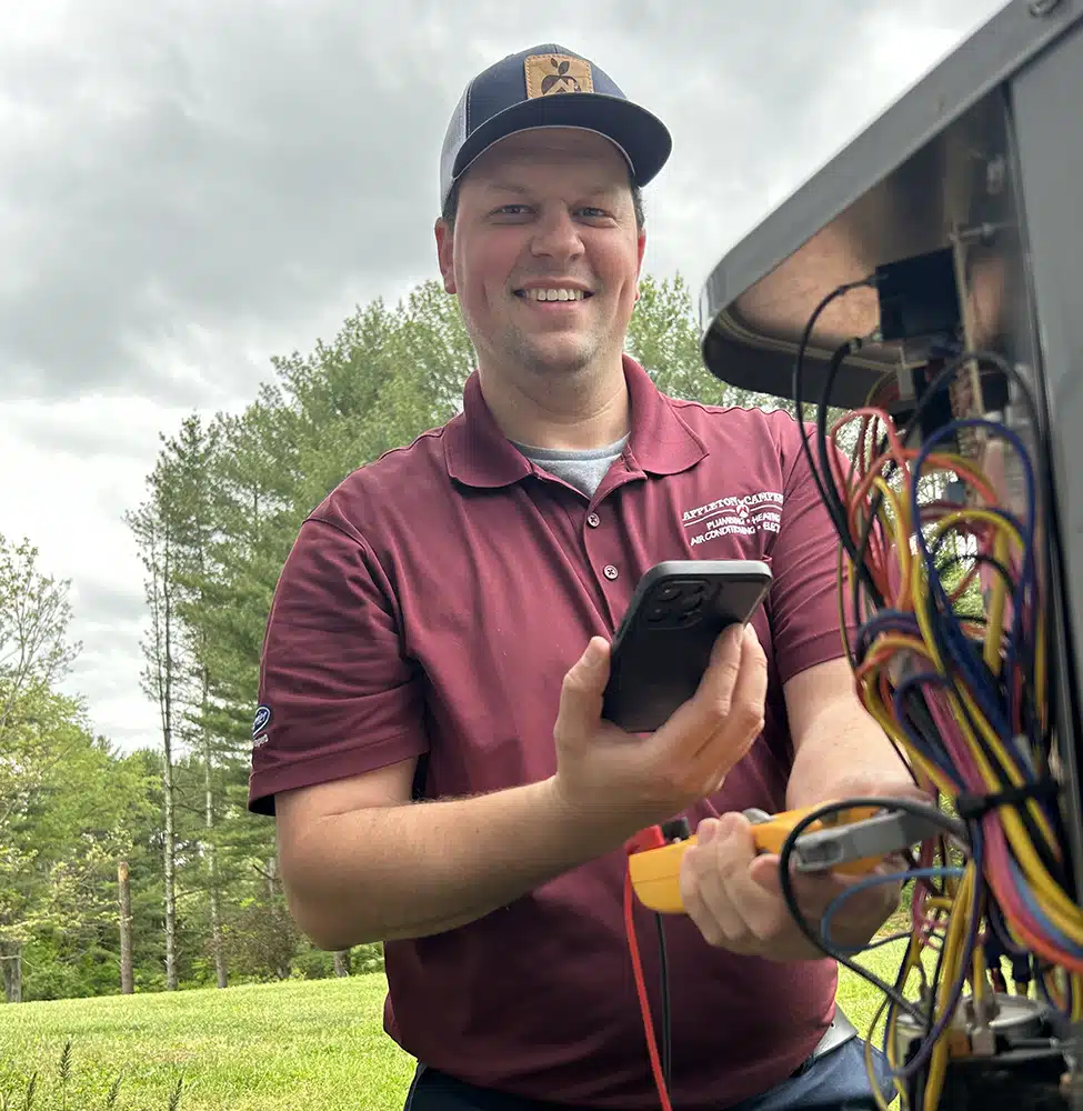 Appleton Campbell electrician servicing AC unit outside of residential home in Warrenton, VA.