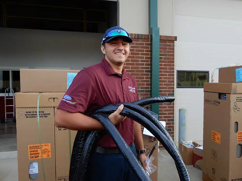 Appleton Campbell technician carrying parts outside of warehouse in Warrenton, VA.