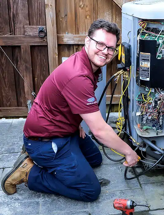 Appleton Campbell HVAC technician doing routine maintenance on an HVAC unit.